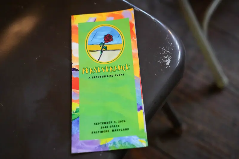 The printed Perseverance program, showing the event date and venue on a green and orange cover.